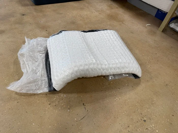 The Titan Plus Core mattress still wrapped in plastic after being unboxed