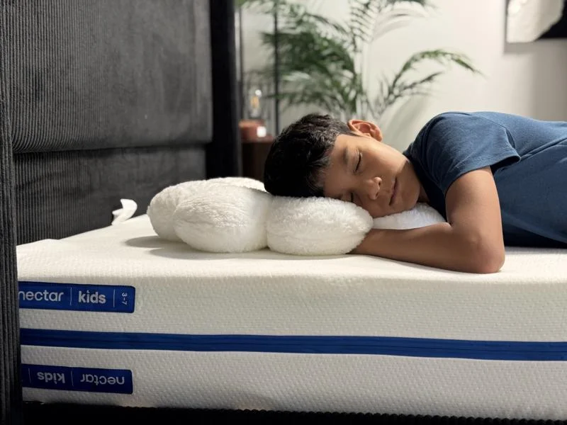 Our young tester stomach-sleeping on a Nectar Kids Mattress