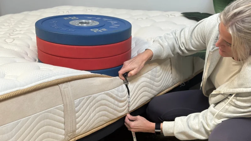 Measuring the sinkage from weight plates along the edge of the Saatva Loom & Leaf Mattress