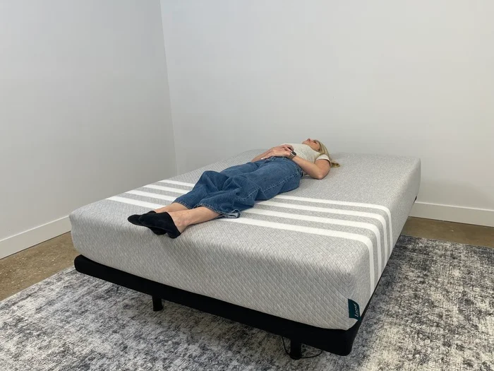 A tester lies on her back on the Leesa Original mattress