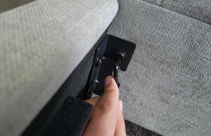 A close-up shot of a hand tightening a hex screw