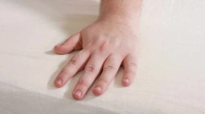 A hand brushes across the Brooklinen Linen Sheets. A hand brushes across the Brooklinen Linen Sheets.