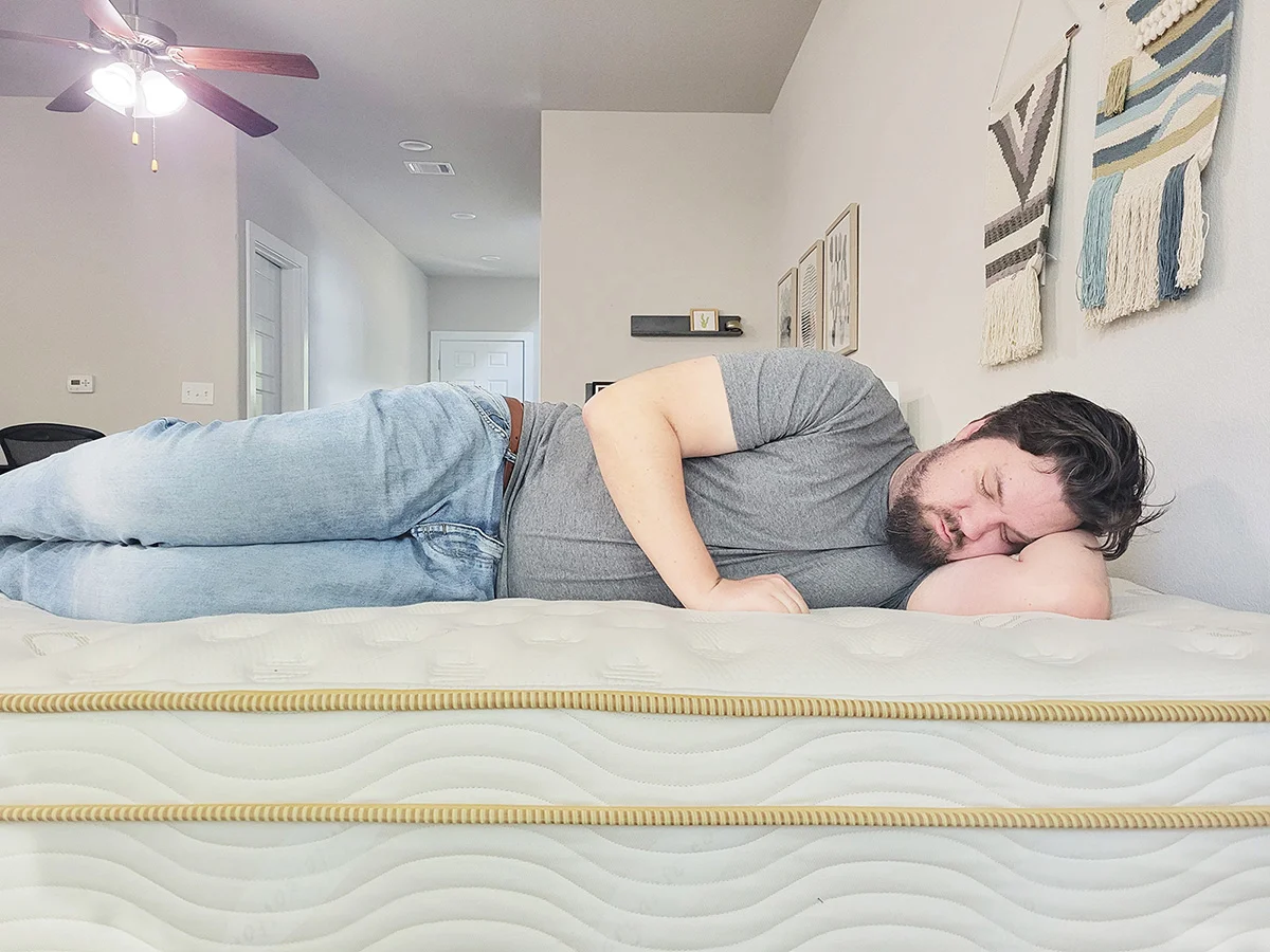 man side sleeping on the Saatva Classic mattress
