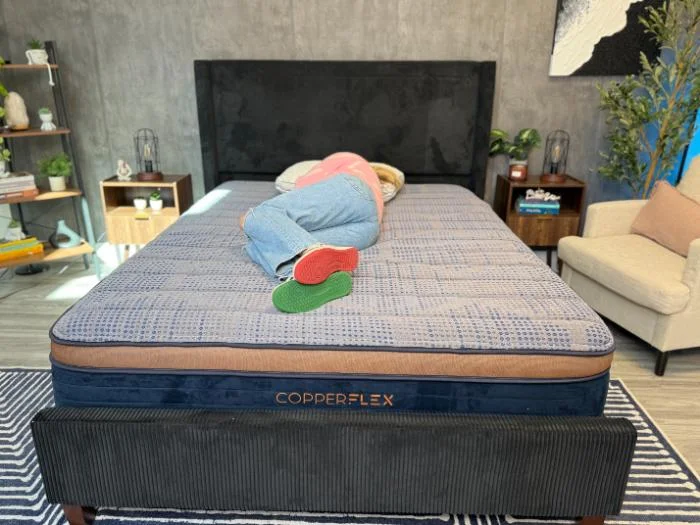 Our tester in a side sleeping position on the CopplerFlex