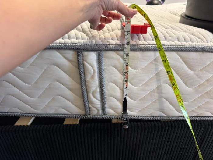 Measuring the 12-inch height of the DLX Classic Two-Sided Mattress