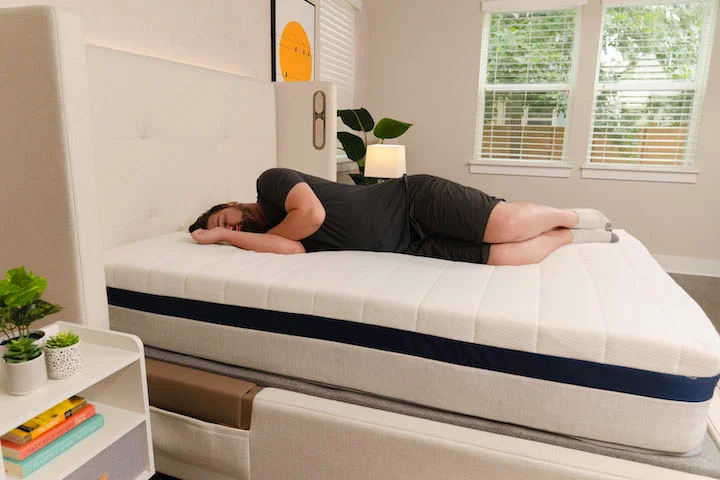 a man sleeps on his side on the Helix Midnight mattress